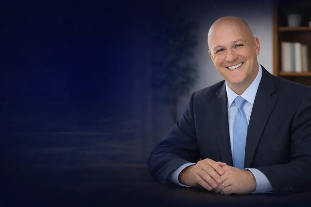 Mortgage protection insurance agent smiling during consultation, professional life insurance advisor helping family protect their home